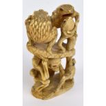 A well carved Japanese Meiji period bone okimono depicting four toads supported by a seated