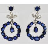 A pair of white metal and diamond sapphire earrings,