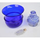 An octagonal faced blue and white paperweight type scent bottle with circular stopper,