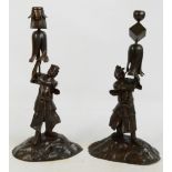 A pair of Japanese Meiji period bronzed figural candle holders,