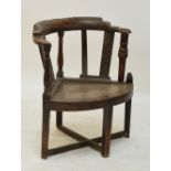 An early 18th century oak bowfronted corner chair with stretchered supports (af).