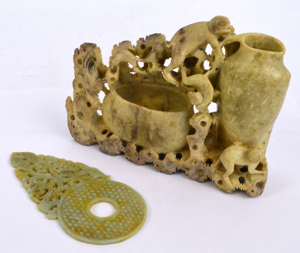 A Chinese carved jade bi disc with textured sides,