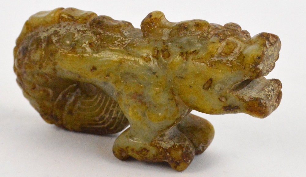 A Chinese russet included jade carving of a dragon-fish, length 7.5 cm.