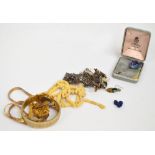 A quantity of costume jewellery including a three coloured metal articulated necklace with matching