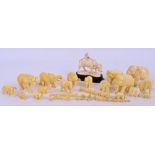 A collection of Japanese Meiji period carved ivory elephants in various sizes, the smallest 0.