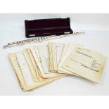 A Rudall Carte Takumi silver flute, stamped 900, cased, with a collection of related sheet music.