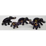 A collection of Limoges models of elephants in gilt heightened cobalt blue,