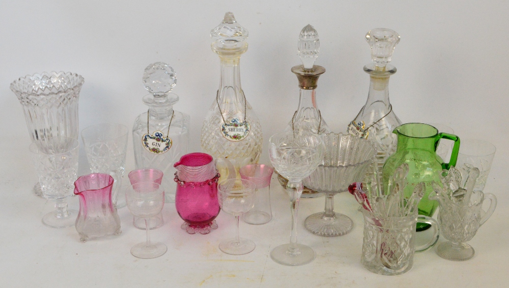 A large quantity of decorative glass including a cranberry tinted jug, various wine glasses,
