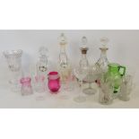 A large quantity of decorative glass including a cranberry tinted jug, various wine glasses,