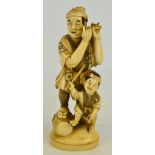 A Japanese Meiji period Tokyo school carved ivory okimono depicting a man playing a flute with his