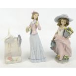 Two Lladro figures of girls holding flowers and a Lladro Society plaque modelled as a dove seated