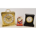 A late 19th century French black slate mantel clock, the white enamel dial set with Roman numerals,