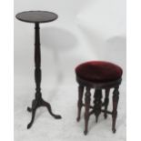 A late 19th century rosewood low circular piano stool with turned legs united by stretchers,