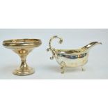 An Elizabeth II hallmarked silver sauce boat with cast decorated rim and S-scroll handle,