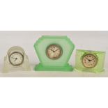 Two Art Deco design glass timepieces and a similar perspex example,