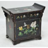 A small decorative Chinese black lacquer cupboard with with raised top sides,