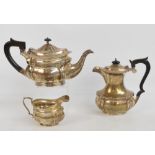 A matched early 20th century English hallmarked silver three piece tea service comprising a teapot