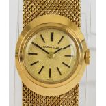 CARAVELLE; a lady's vintage 9ct gold wristwatch with integral textured bracelet, length 16cm,