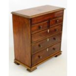 A 19th century mahogany miniature/apprentice chest of two short and three long drawers with shield