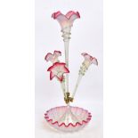 A Victorian opaque and cranberry tinted glass epergne with central flared trumpet stem,