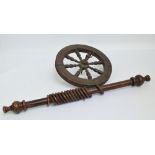 A short wooden curtain pole with rings, length 77cm, and a wheel from a spinning wheel, diameter 33.