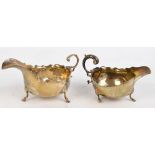 Two similar hallmarked silver sauce boats with shaped rims and C-scroll handles,