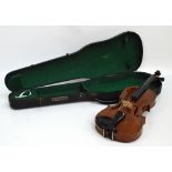 A three quarter sized German violin with two-piece back, length 34cm, unlabelled, cased.