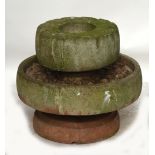 A large circular composite stone bird bath with central well and surrounding pebble effect,