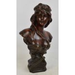 A spelter bust of a semi naked maiden with a dagger to the square base with canted corners,