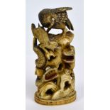 A Japanese Meiji period carved ivory okimono seal, decorated with an eagle above a wolf,