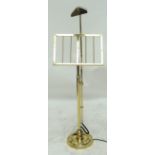 A contemporary brass music stand with fixed top light.
