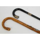 An ebonised walking stick with hallmarked silver mount and collar with inscription "Presented to J