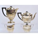An Elizabeth II hallmarked silver four piece tea set comprising a teapot of oval form with