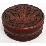 A Chinese cinnabar decorated circular box and cover with incised decorated sides and large