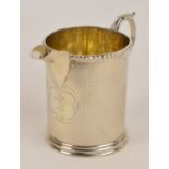 A Victorian hallmarked silver jug with overall engine turned decoration and loop handle,