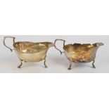 Two similar George V hallmarked silver sauce boats, one with shaped rim and engraved HC 1918,