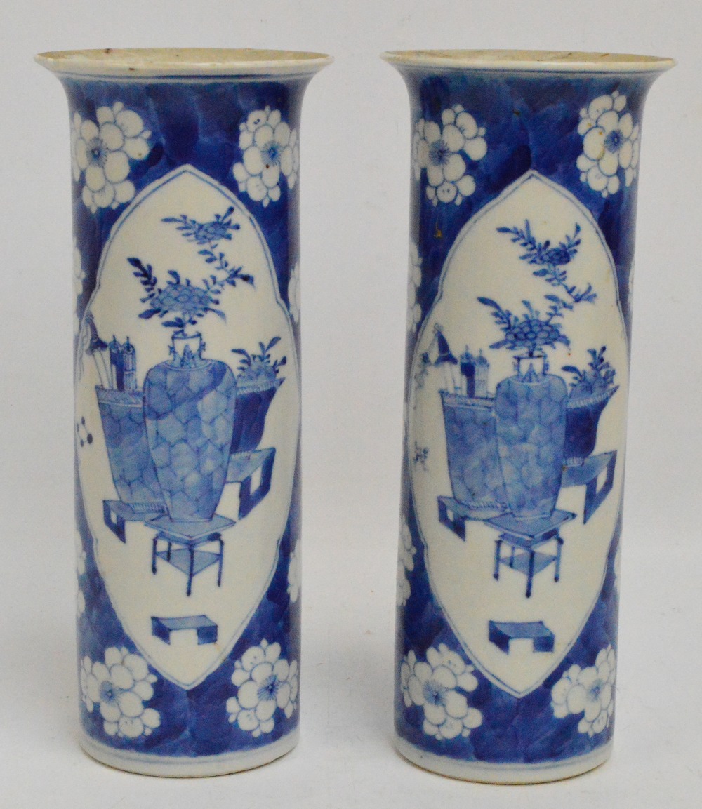 A pair of 19th century Chinese porcelain sleeve vases painted in underglaze blue with two opposing