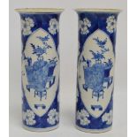A pair of 19th century Chinese porcelain sleeve vases painted in underglaze blue with two opposing