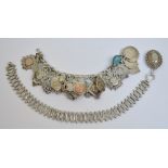 A hallmarked silver charm bracelet with T-bar, suspending nineteen silver vacant medallions,