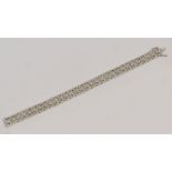 A 9ct textured white gold and diamond chip openwork bracelet, length 18.5cm, approx 11.3g.
