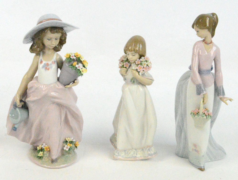Three Lladro figures of various girls holding flowers (3).