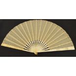 A late 19th century folding dance fan with pierced and carved bone guard and sticks studded with