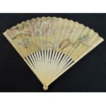 A 19th century Japanese folding fan with ivory guards with an inscribed floral pattern,