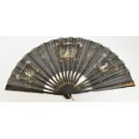 A 19th century French folding fan with gilt heightened black painted guards and sticks,
