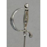 A Charles Horner hallmarked silver hat pin in the form of a sword with smooth grip and knuckle