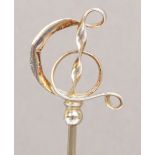 A Charles Horner hallmarked silver hat pin of abstract looped ribbon musical clef form,