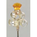 A Charles Horner hallmarked silver hat pin in the form of a citrine coloured glass thistle set on