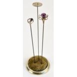 A Charles Horner hallmarked silver hat pin in the form of a thistle with an amethyst coloured glass