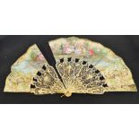 A Victorian pastiche folding fan with shaped carved and pierced bone guards and sticks,
