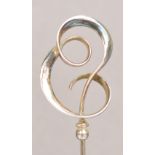 A Charles Horner hallmarked silver hat pin of looped ribbon abstract form, Chester 1910,